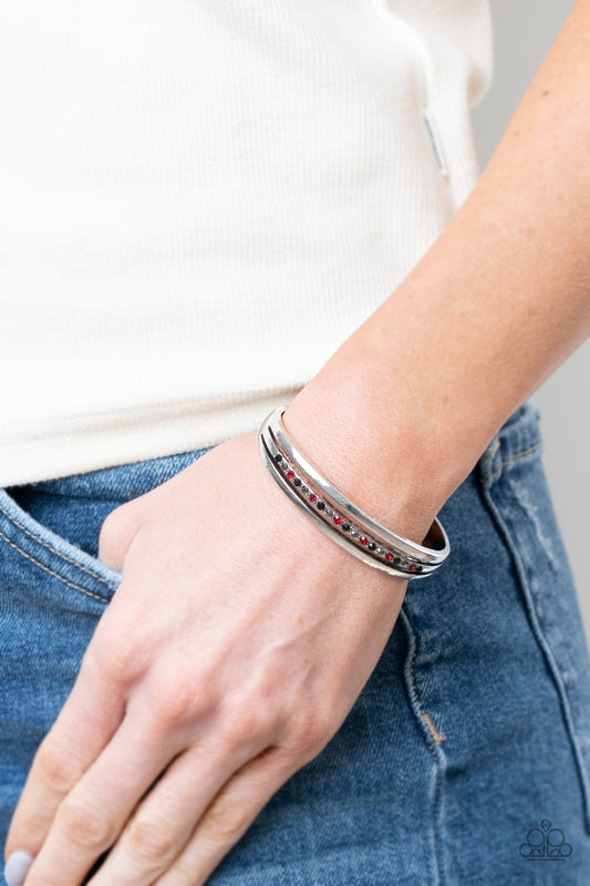 A Point Of Pride Multi Cuff Bracelet - Paparazzi Accessories  Two glistening silver bars flank a row of black, red, and hematite rhinestones, coalescing into a dainty layered cuff around the wrist for a dash of refined edge.  All Paparazzi Accessories are lead free and nickel free!   Sold as one individual bracelet.