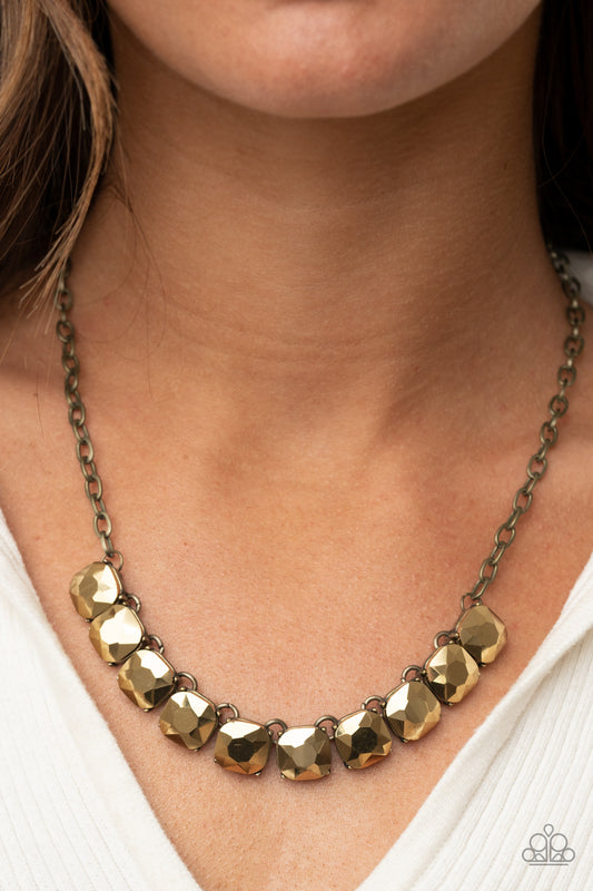 Radiance Squared Brass Necklace - Paparazzi Accessories  A succession of gleaming radiant-cut aurum gems attaches to a brass chain and falls below the collar for an edgy show-stopping display. Features an adjustable clasp closure.  All Paparazzi Accessories are lead free and nickel free!  Sold as one individual necklace. Includes one pair of matching earrings.