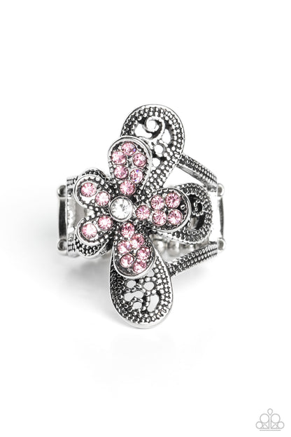 Garden Escapade Pink Ring - Paparazzi Accessories  Dotted with a dainty white rhinestone center, silver petals overlaid with glittery pink rhinestones, sit atop studded silver filigree petals, creating a frilly floral centerpiece atop the finger. Features a stretchy band for a flexible fit.  Sold as one individual ring.  P4RE-PKXX-224XX