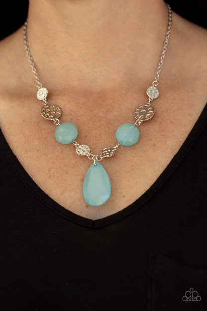 DEW What You Wanna DEW Blue Necklace - Paparazzi Accessories  A dewy Cerulean teardrop swings from the bottom of interlinking hammered silver discs and matching dewy Cerulean crystal-like beads, creating a dreamy display below the collar. Features an adjustable clasp closure.  All Paparazzi Accessories are lead free and nickel free!  Sold as one individual necklace. Includes one pair of matching earrings.
