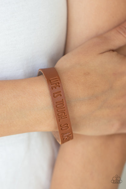 Life is Tough Brown Wrap Bracelet - Paparazzi Accessories  A dainty brown leather band is stamped in the phrase, "Life is tough. So Are You.," creating an inspiring centerpiece around the wrist. Features an adjustable snap closure.  All Paparazzi Accessories are lead free and nickel free!  Sold as one individual bracelet.