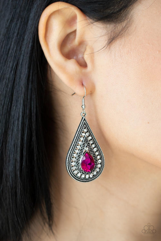 Metro Masquerade Pink Earring - Paparazzi Accessories  An elaborate silver teardrop frame, adorned with a rope-like border and dainty white rhinestones, encases a brilliant pink teardrop gem creating a stunningly captivating lure. Earring attaches to a standard fishhook fitting.  Sold as one pair of earrings.