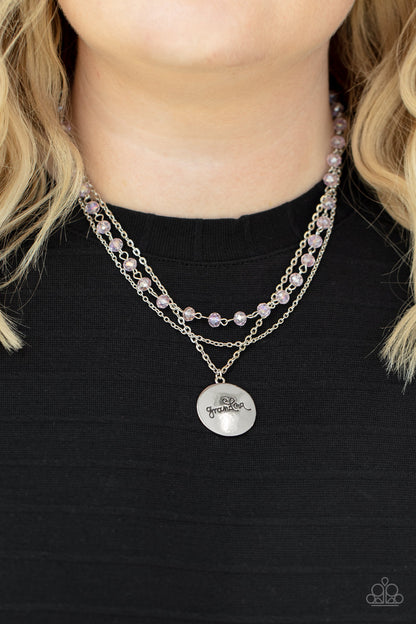 Promoted to Grandma Pink Necklace - Paparazzi Accessories  Infused with a strand of iridescent pink crystal-like beads, two dainty rows of mismatched silver chains delicately layer below the collar. Stamped in the word, "Grandma," a shiny silver disc swings from the lowest chain, creating a loving pendant. Features an adjustable clasp closure.  Sold as one individual necklace. Includes one pair of matching earrings.