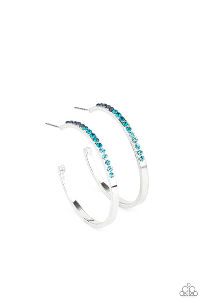Somewhere Over the OMBRE Blue Hoop Earring - Paparazzi Accessories  The front half of a dainty silver hoop is encrusted in an ombre of blue rhinestones, creating a sparkly spectrum of color. Earring attaches to a standard post fitting. Hoop measures approximately 1 1/2" in diameter.  Sold as one pair of hoop earrings.