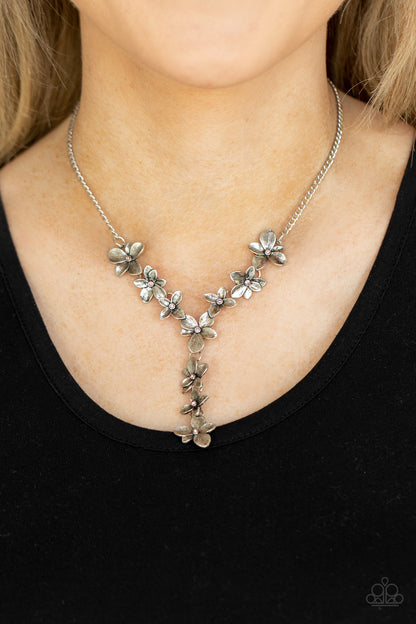 Fairytale Meadow Pink Necklace - Paparazzi Accessories  Dotted with dainty pink rhinestone centers, whimsical silver flowers delicately link into an extended pendant below the collar for an ethereal fashion. Features an adjustable clasp closure.  Sold as one individual necklace. Includes one pair of matching earrings.