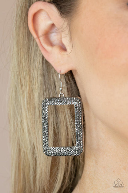 World FRAME-ous Silver Earring - Paparazzi Accessories  Bordered in rows of smoky hematite rhinestones, an oversized silver rectangular frame swings from the ear for a fashionable finish. Earring attaches to a standard fishhook fitting.  All Paparazzi Accessories are lead free and nickel free!  Sold as one pair of earrings.