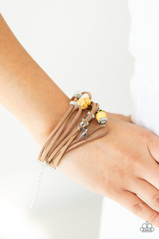 Canyon Flight Yellow Urban Bracelet - Paparazzi Accessories  Infused with a dainty silver bird charm, dainty strands of brown suede are adorned in mismatched silver accents and yellow stones for an earthy layered look. Features an adjustable clasp closure.  All Paparazzi Accessories are lead free and nickel free!  Sold as one individual bracelet.