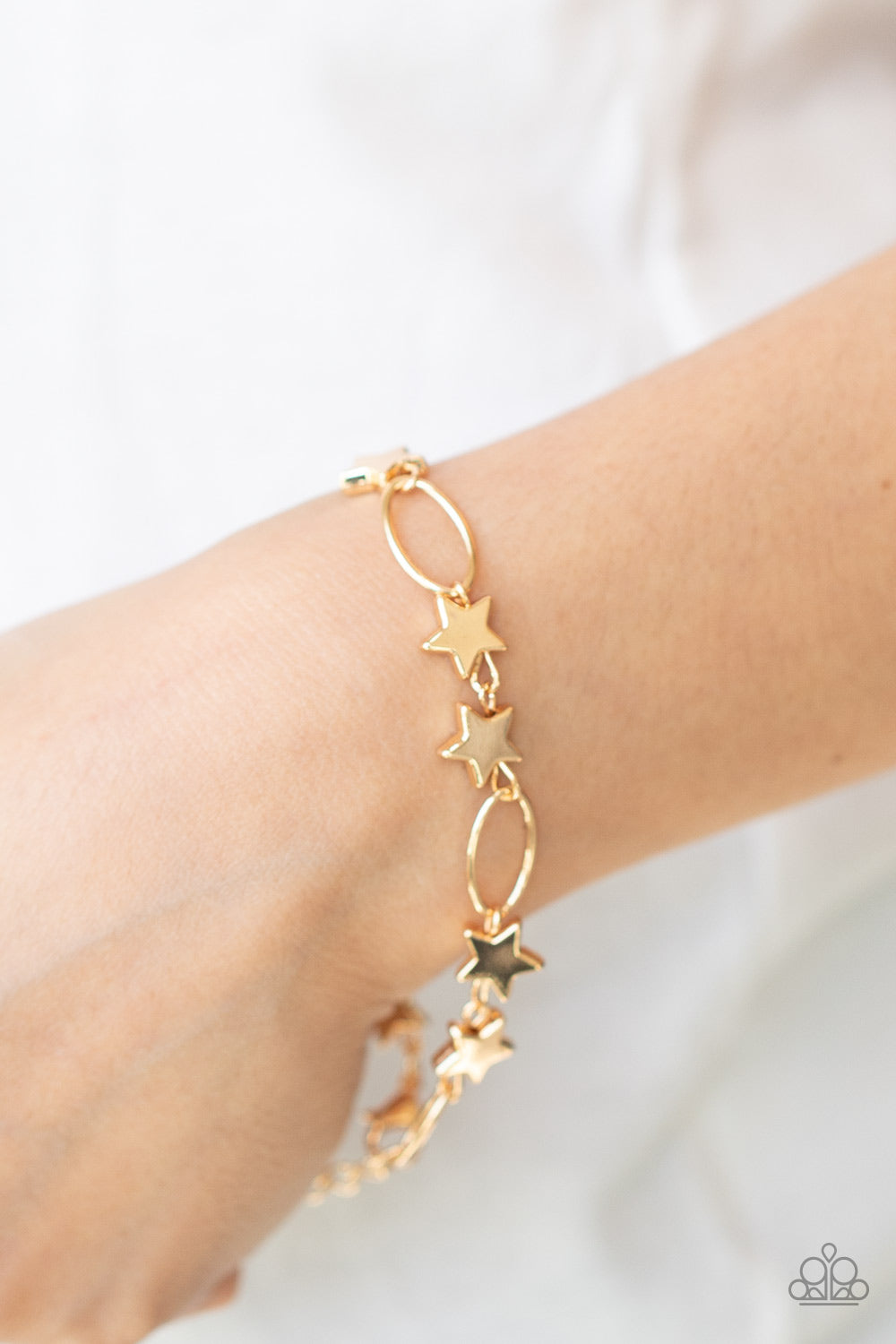 Stars and Sparks Gold Bracelet - Paparazzi Accessories  Dainty gold stars and airy gold ovals delicately link around the wrist, creating a stellar 4th of July display. Features an adjustable clasp closure.  All Paparazzi Accessories are lead free and nickel free!  Sold as one individual bracelet.