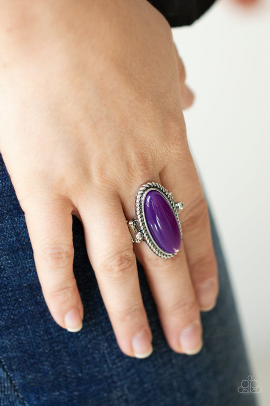 Oval Oasis Purple Ring - Paparazzi Accessories  Featuring a glassy iridescence, an oval purple acrylic bead is pressed into the center of textured silver fittings, creating a mystical centerpiece atop the finger. Features a dainty stretchy band for a flexible fit.  Sold as one individual ring.