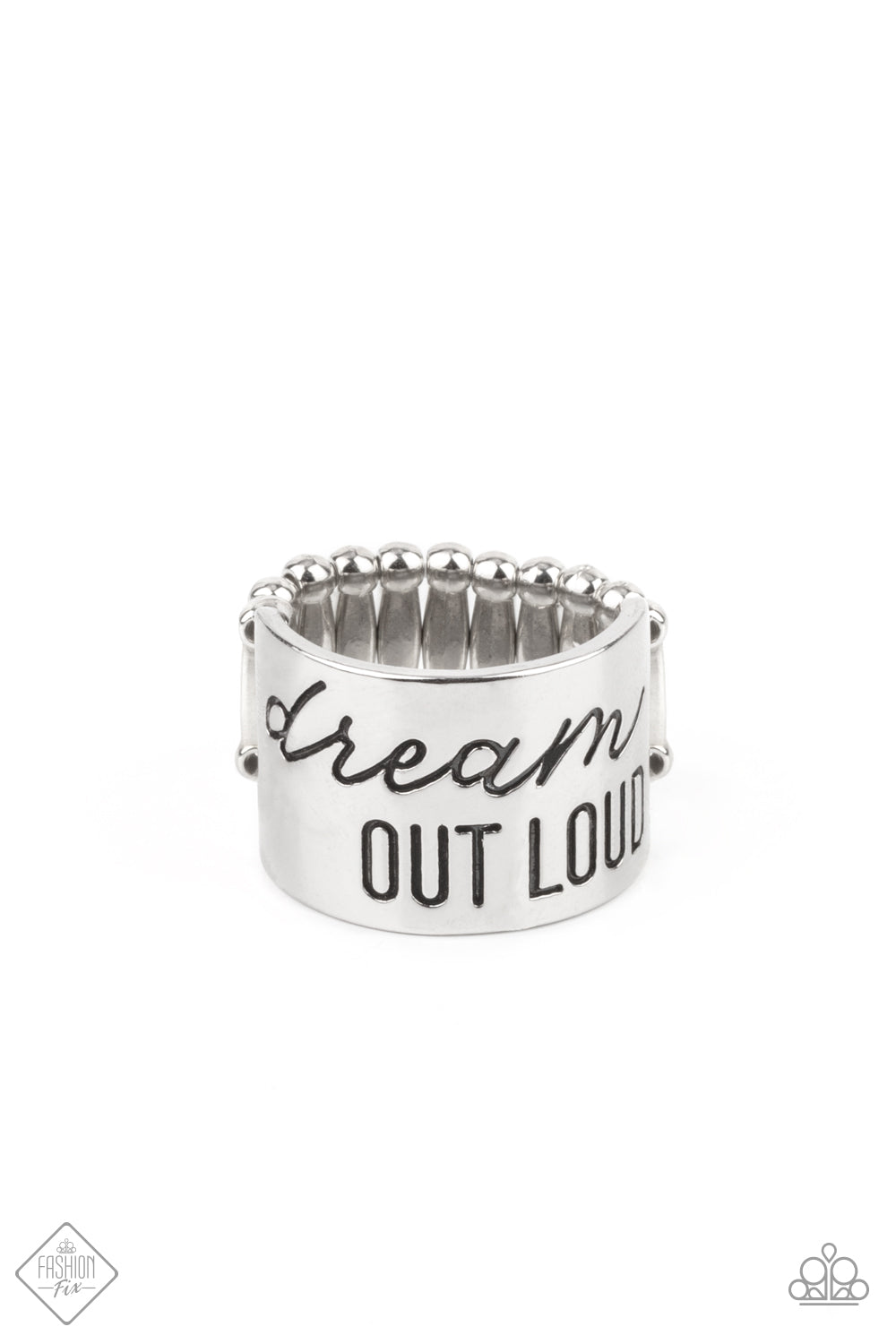 Dream Louder Silver Ring - Paparazzi Accessories  The front of a thick silver band is stamped in the phrase, "Dream out loud," creating an inspirational centerpiece across the finger. Features a stretchy band for a flexible fit.  All Paparazzi Accessories are lead free and nickel free!  Sold as one individual ring.