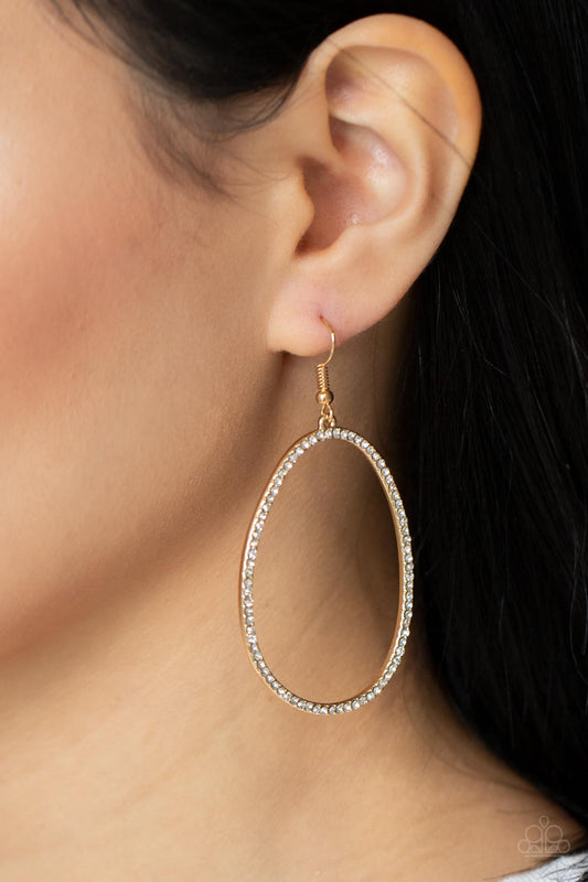 OVAL-ruled! Gold Earring - Paparazzi Accessories  Dotted in dainty white rhinestones, an asymmetrical oval gold frame swings from the ear for a sassy look. Earring attaches to a standard fishhook fitting.  All Paparazzi Accessories are lead free and nickel free!  Sold as one pair of earrings.