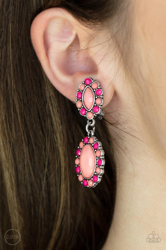 Positively Pampered Orange Clip-On Earring - Paparazzi Accessories  Bordered in dainty Burnt Coral and Raspberry Sorbet beads, a pair of marquise and oval Burnt Coral beads delicately link into a colorful lure for a fresh pop of color. Earring attaches to a standard clip-on fitting.  All Paparazzi Accessories are lead free and nickel free!  Sold as one pair of clip-on earrings.