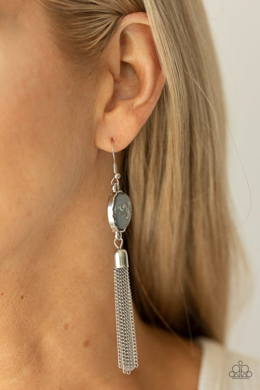 Oceanic Opalescence Silver Earring - Paparazzi Accessories  Flecks of shells are encased in a glassy gray bead that is encased in a hammered silver frame. A silver chain tassel swings from the bottom of an iridescent frame, creating an ethereal display. Earring attaches to a standard fishhook fitting.  Sold as one pair of earrings.