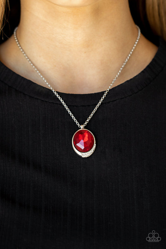 Fashion Finale Red Necklace - Paparazzi Accessories  An oversized red gem is pressed into a sleek silver fitting dipped in dainty white rhinestones, creating a glamorous pendant at the bottom of a dainty silver chain. Features an adjustable clasp closure.  Sold as one individual necklace. Includes one pair of matching earrings.