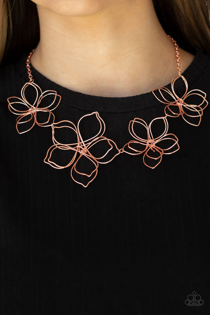 Flower Garden Fashionista Copper Necklace - Paparazzi Accessories  Shiny copper wire delicately twists into oversized blossoms. Varying in size, the airy floral frames delicately link into an asymmetrical display as the layered frames elegantly pop beneath the collar. Features an adjustable clasp closure.  All Paparazzi Accessories are lead free and nickel free!  Sold as one individual necklace. Includes one pair of matching earrings.