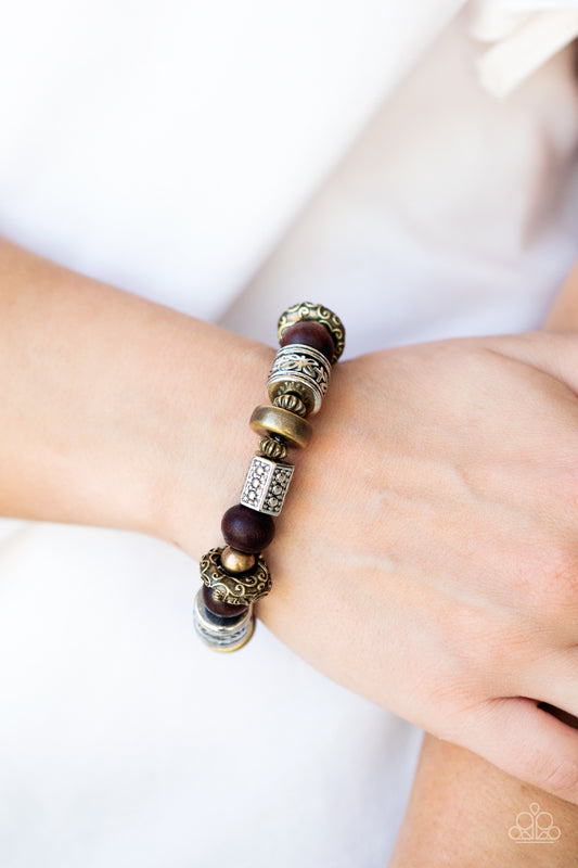Exploring The Elements Multi Bracelet - Paparazzi Accessories  Stamped, studded, and embossed in tribal inspired patterns, a collection of chunky brass and silver beads join earthy wooden beads along a stretchy band around the wrist for an earthy flair.  All Paparazzi Accessories are lead free and nickel free!  Sold as one individual bracelet.
