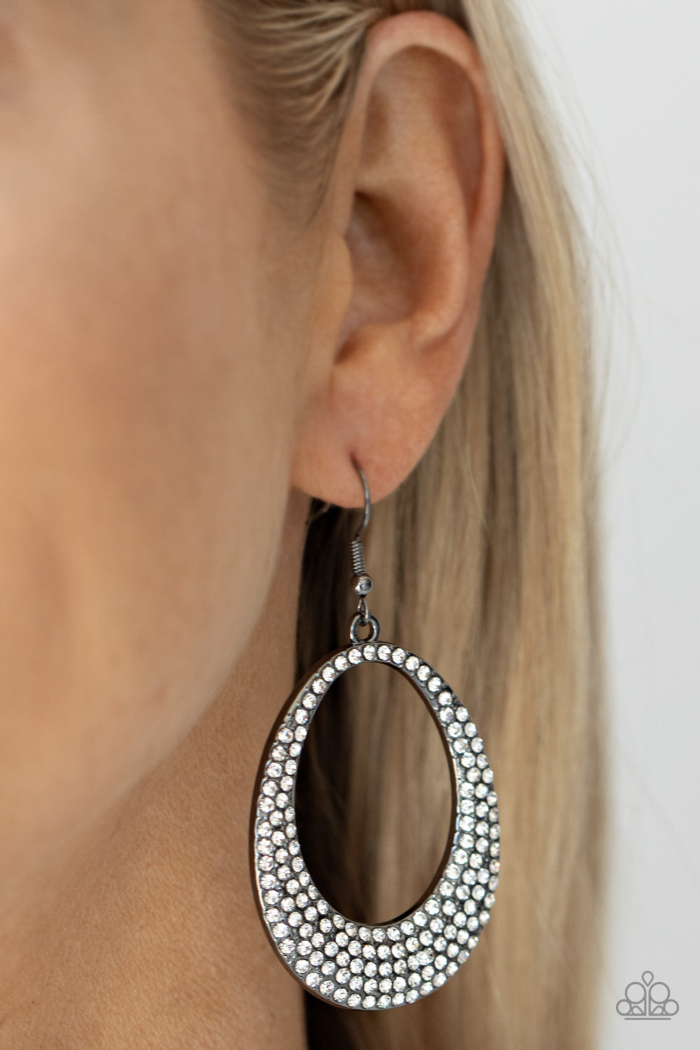 Storybook Bride Black Earring - Paparazzi Accessories  Shiny gunmetal oval frames with airy cut-out centers, are covered in brilliant white rhinestones, creating an enchanting lure. Earring attaches to a standard fishhook fitting.  All Paparazzi Accessories are lead free and nickel free!  Sold as one pair of earrings.