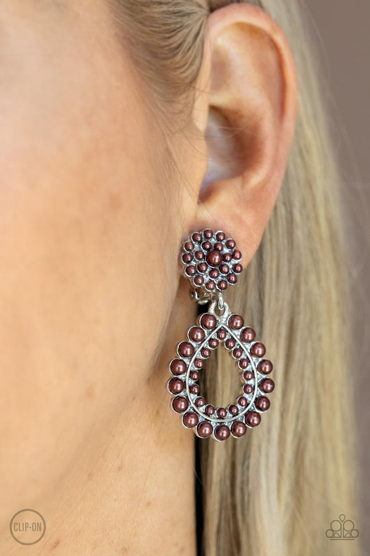 Discerning Droplets Brown Clip-On Earring - Paparazzi Accessories  Droplets of coffee-colored pearls dot the surface of a silver teardrop frame as it suspends from a round pearl-encrusted disc for a classically dewy finish. Earring attaches to a standard clip-on fitting.  All Paparazzi Accessories are lead free and nickel free!  Sold as one pair of clip-on earrings.