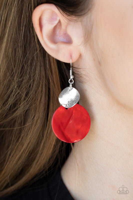 Opulently Oasis Red Earring - Paparazzi Accessories  An oversized shell-like disc is topped by a wavy, sparkling silver disc. The pair sways dramatically from a silver fitting for a breezy finish. Earring attaches to a standard fishhook fitting.  All Paparazzi Accessories are lead free and nickel free!  Sold as one pair of earrings.