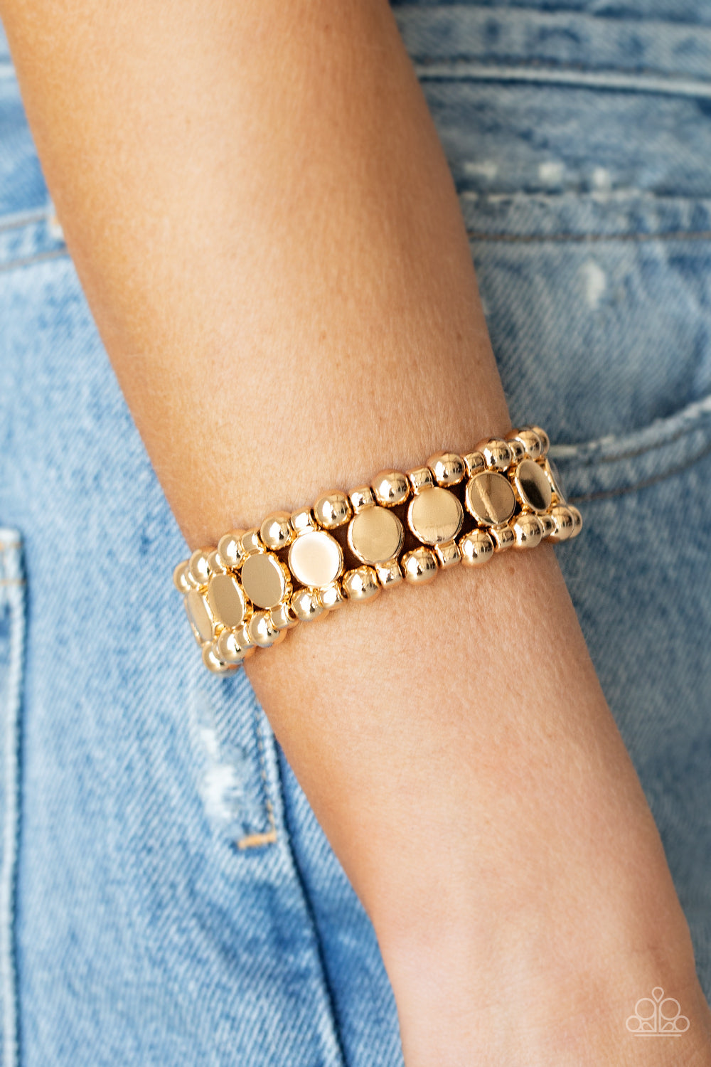 Metro Magnetism Gold Bracelet - Paparazzi Accessories  Glistening gold disc fittings and pairs of classic gold beads are threaded along stretchy bands around the wrist that connect into a bold industrial display around the wrist.  All Paparazzi Accessories are lead free and nickel free!  Sold as one individual bracelet.