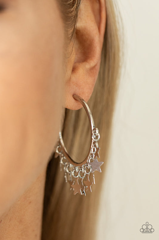 Happy Independence Day Silver Hoop Earring - Paparazzi Accessories  A shiny collection of silver star charms trickles from the bottom of a classic silver hoop, creating a stellar fringe. Earring attaches to a standard post fitting. Hoop measures approximately 1 1/4" in diameter.  Sold as one pair of hoop earrings.