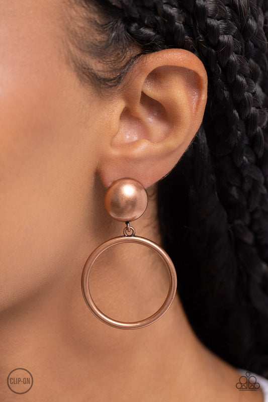 Classic Candescence Copper Clip-On Earring - Paparazzi Accessories  Brushed in an antiqued shimmer, a copper hoop swings from the bottom of an oversized copper stud for a classic metallic look. Earring attaches to a standard clip-on fitting.  Sold as one pair of clip-on earrings.  Sku:  P5CO-CPXX-015XX