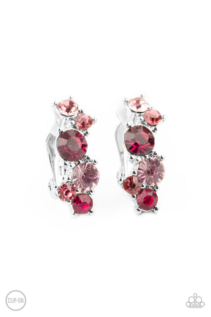 Cosmic Celebration Pink Clip-On Earring - Paparazzi Accessories  Varying in shades of pink, mismatched rhinestones delicately coalesce into a dainty frame for a colorfully sparkly display. Earring attaches to a standard clip-on fitting.  Sold as one pair of clip-on earrings.