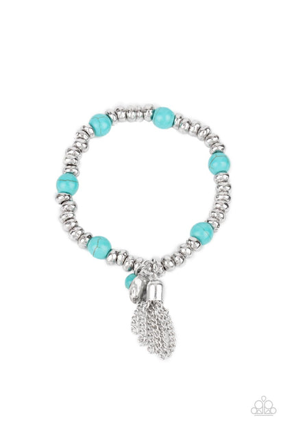 Whimsically Wanderlust Blue Bracelet - Paparazzi Accessories  An earthy collection of hammered silver beads and round turquoise stones are threaded along a stretchy band around the wrist. A dainty silver tassel, hammered silver disc, and a turquoise stone swing from the seasonal display, adding playful movement to the whimsy look.  All Paparazzi Accessories are lead free and nickel free!  Sold as one individual bracelet.