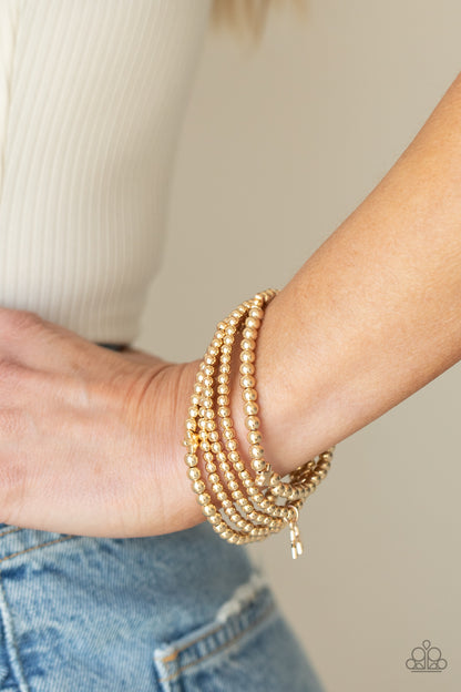 American All-Star Gold Bracelet - Paparazzi Accessories  Infused with dainty gold star beads and shiny gold star charms, strands of gold beaded stretchy bands stack across the wrist, creating a patriotic shimmer.  All Paparazzi Accessories are lead free and nickel free!  Sold as one set of five bracelets.