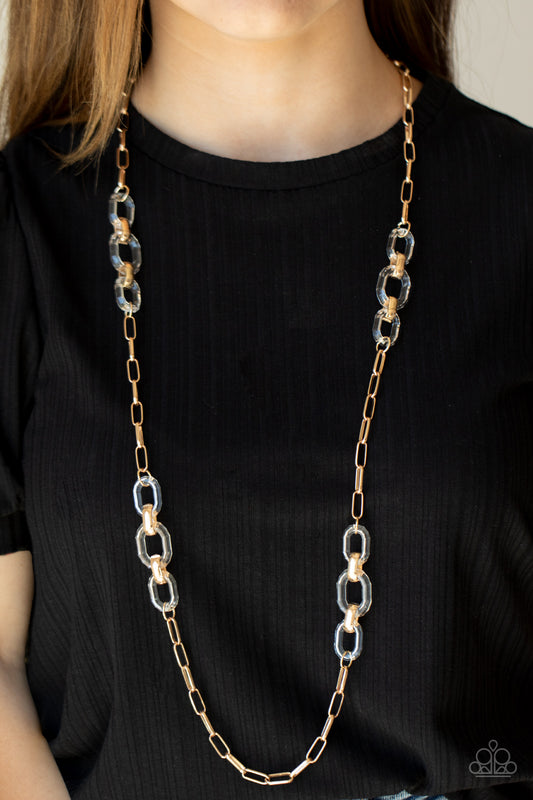 Have I Made Myself Clear? Gold Necklace - Paparazzi Accessories. Sections of oversized clear acrylic and bold gold links connect with an exaggerated gold chain across the chest, creating an intense industrial display. Features an adjustable clasp closure.  All Paparazzi Accessories are lead free and nickel free!  Sold as one individual necklace. Includes one pair of matching earrings.