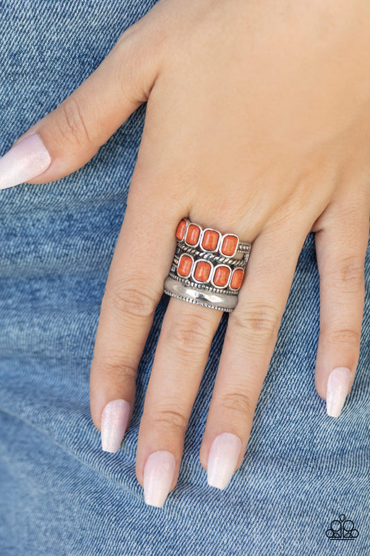 Mojave Monument Orange Ring - Paparazzi Accessories   Mismatched rows of Adobe rectangular stone beads, twisted silver and studded silver bars, and a faceted silver band haphazardly layer across the finger, coalescing into a colorfully rustic centerpiece. Features a stretchy band for a flexible fit.  ﻿All Paparazzi Accessories are lead free and nickel free!  Sold as one individual ring.