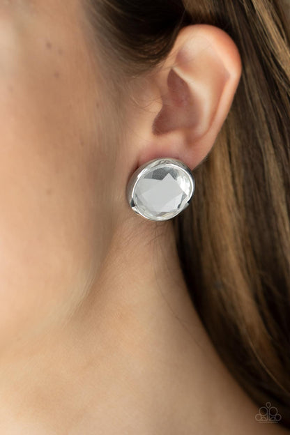 Double-Take Twinkle White Post Earring - Paparazzi Accessories  Featuring a flashy faceted finish, an oversized white gem is pressed into a sleek silver fitting for a dramatic pop of dazzle. Earring attaches to a standard post fitting.  All Paparazzi Accessories are lead free and nickel free!   Sold as one pair of post earrings.