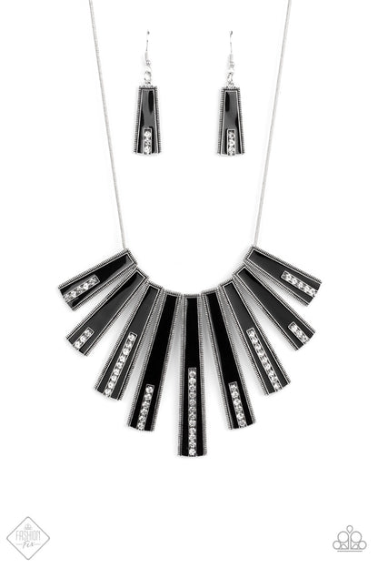 FAN-tastically Deco Black Necklace - Paparazzi Accessories  Elongated flared frames are painted in a glossy black finish and bordered by studded texture as they fan out along the collar. A row of rhinestones runs up the center of each frame, adding spectacular sparkle to the display as the pieces sway from a round silver chain. Features an adjustable clasp closure.  All Paparazzi Accessories are lead free and nickel free!  Sold as one individual necklace. Includes one pair of matching earrings.