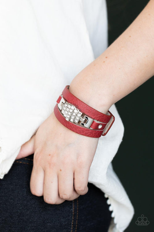 Ultra Urban Red Wrap Bracelet - Paparazzi Accessories  A white rhinestone silver centerpiece is studded in place by white rhinestone encrusted silver studs across the spliced center of a red leather band, creating a glittery urban look around the wrist. Features an adjustable snap closure.  Sold as one individual bracelet.