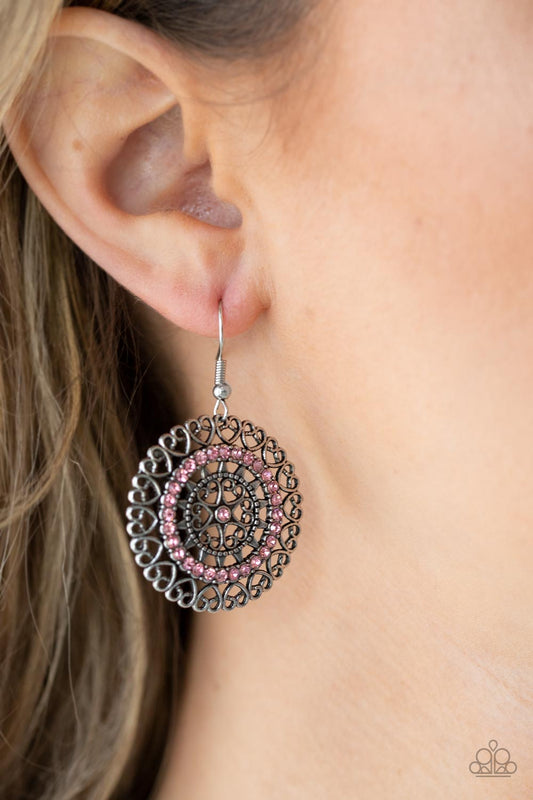 Fairytale Finale Pink Earring - Paparazzi Accessories  Silver heart shaped filigree frames spin into an enchanting display. Infused with a ring of glassy pink rhinestones, the center of the airy frame is dotted with a solitaire pink rhinestone for a romantic finish. Earring attaches to a standard fishhook fitting.  All Paparazzi Accessories are lead free and nickel free!  Sold as one pair of earrings.