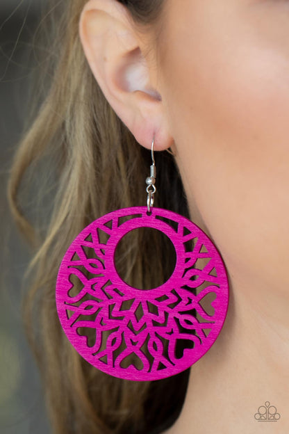 Tropical Reef Pink Wooden Earring - Paparazzi Accessories  Painted in a vibrant pink, an airy circular wooden frame features a cut-out heart motif reminiscent of bohemian designs creating a free-spirited allure. Earring attaches to a standard fishhook fitting.  Sold as one pair of earrings.
