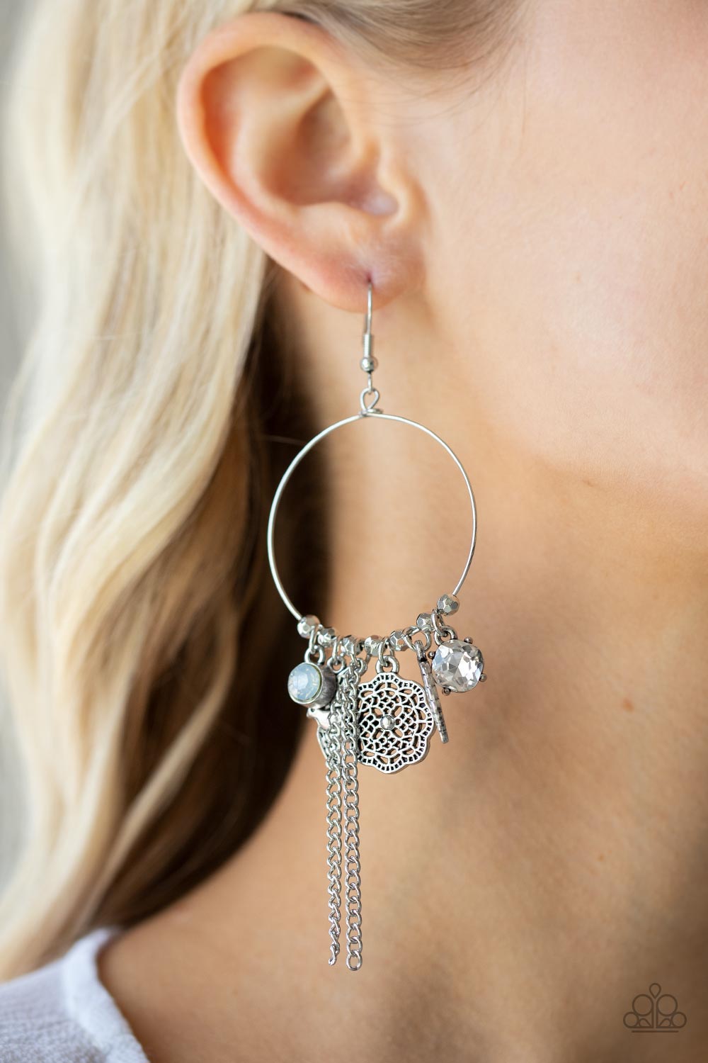 TWEET Dreams White Earring - Paparazzi Accessories  Free-spirited charms, including opal and white gems, a floral medallion, a bird in flight, and a fluttering feather, dangle from a dainty silver ring coalescing into a charming lure. Earring attaches to a standard fishhook fitting.  All Paparazzi Accessories are lead free and nickel free!  Sold as one pair of earrings.