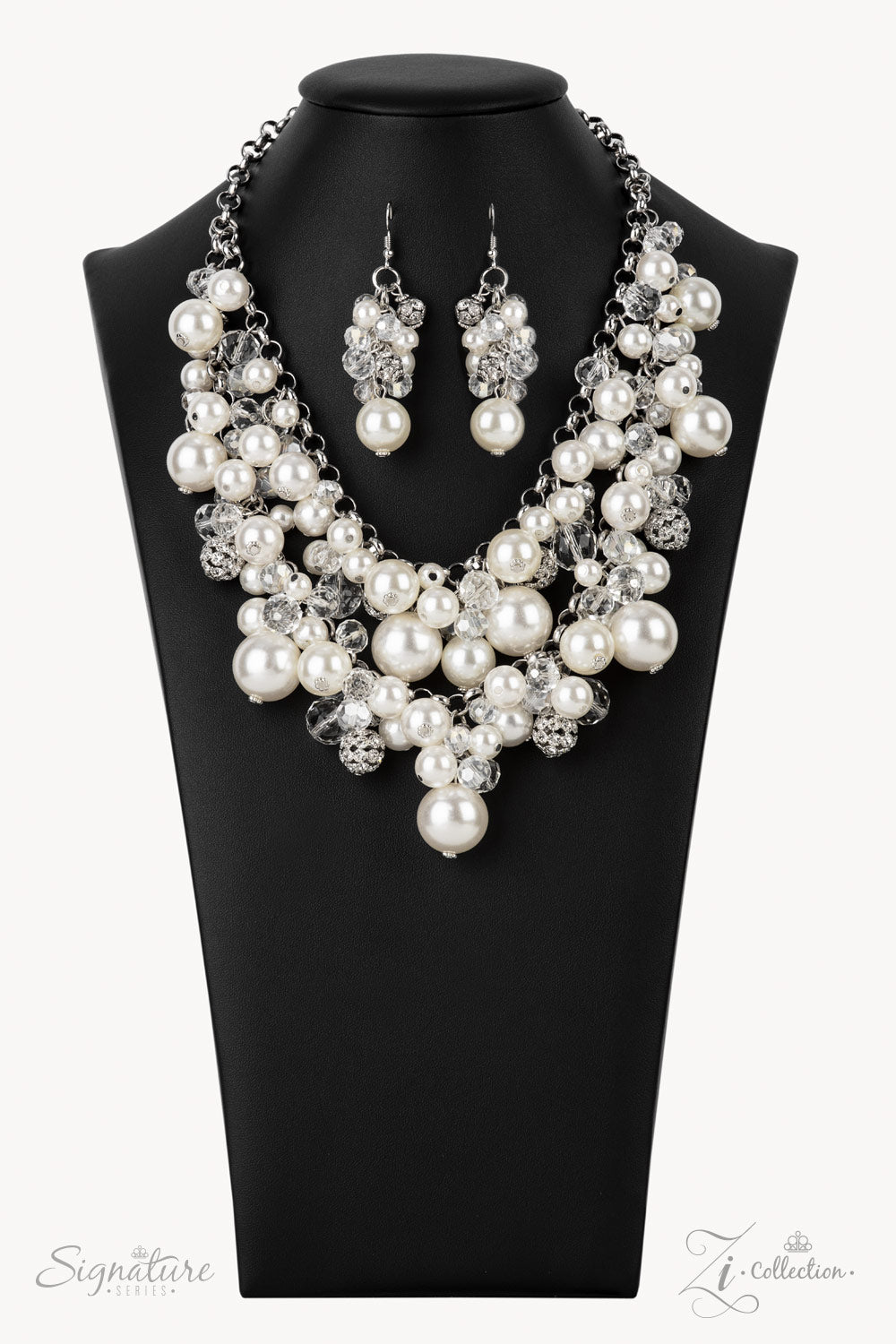 An elegantly effervescent collection of oversized pearls, glassy crystal-like beads, and white rhinestone studded silver ornaments effortlessly clusters along two bold silver chains below the collar. The bubbly bunched accents glamorously gather into a brilliantly boisterous fringe for an uproarious uptown fashion. Features an adjustable clasp closure.  All Paparazzi Accessories are lead free and nickel free!