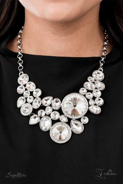 Featuring an oversized collection of round, oval, and teardrop white rhinestones, an exaggerated explosion of dynamite dazzle coalesces into three separate frames below the collar. The combustible frames flawlessly link into a mismatched arrangement of legendary sparkle. Features an adjustable clasp closure.  All Paparazzi Accessories are lead free and nickel free!  Named after the 2021 Seize the Spotlight winner, Danielle V.  Sold as one individual necklace. Includes one pair of matching earrings.