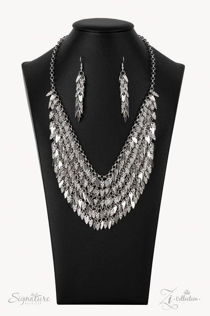 Enhanced with edgy sharpened tips, a seemingly infinite display of plain silver and white rhinestone encrusted teardrop discs dauntlessly drips from an interconnected backdrop of sleek silver links. The ferocious display of alternating dazzle fearlessly dances to its own beat, creating a flirtatiously fierce fringe below the collar. Features an adjustable clasp closure.  All Paparazzi Accessories are lead free and nickel free!   Named after the 2021 Seize the Spotlight winner, NaKisha M