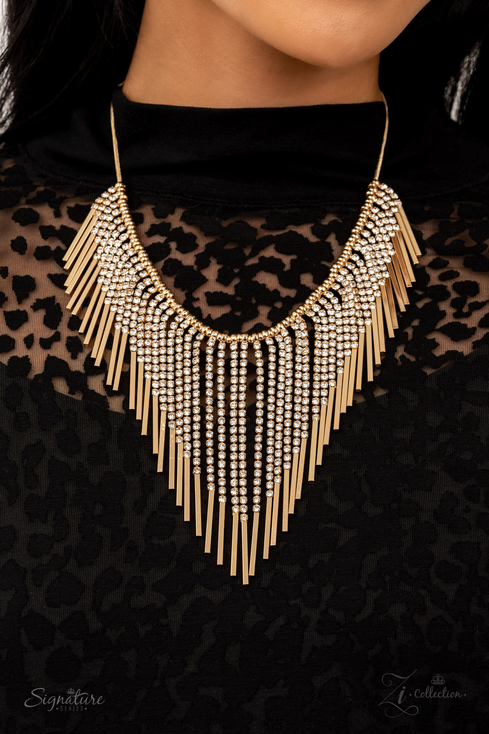 Seemingly separated by dainty gold beads, shimmery strands of white rhinestones majestically morph into gold rectangular frames along a sleekly rounded snake chain. The glamorously golden getup stacks into timelessly tapered tassels, creating a flauntable fringe below the collar. Features an adjustable clasp closure.  All Paparazzi Accessories are lead free and nickel free!  Named after the 2021 Seize the Spotlight winner, Amber B. Sold as one individual necklace. Includes one pair of matching earrings.