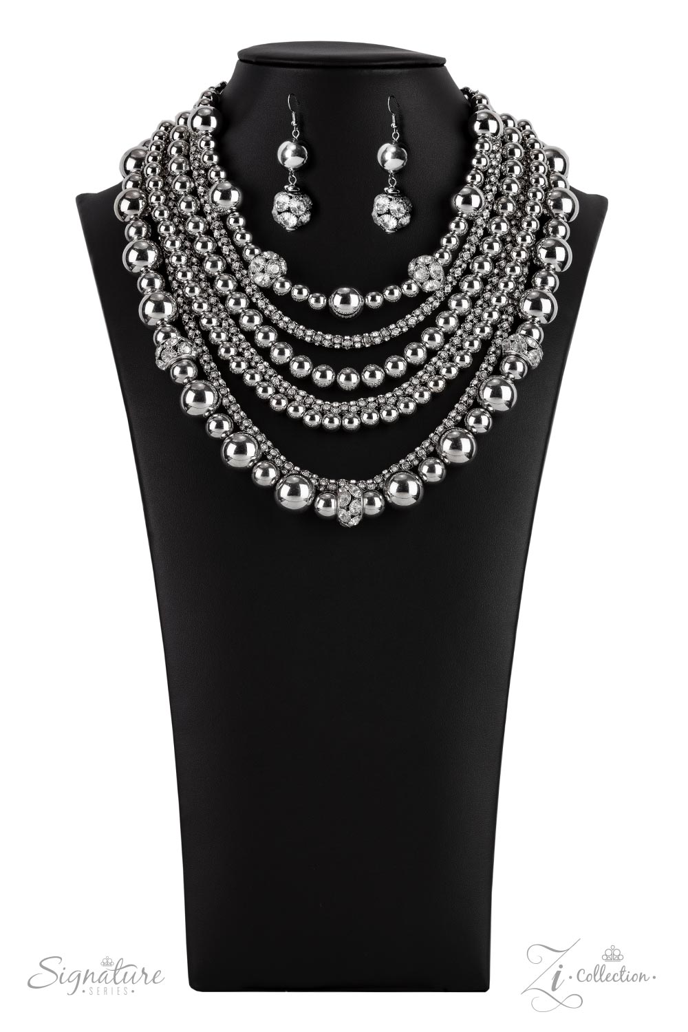 Held together by rectangular silver frames, a couture-clutching collection of oversized silver beads interspersed with white rhinestone encrusted ornaments alternates with interlocking rows of white rhinestone encrusted chains across the chest. Edgily enhanced with linked rows of silver chain fittings, the emboldened silver layers demand to be seen with their unapologetic attitude. Features an adjustable clasp closure.  All Paparazzi Accessories are lead free and nickel free!