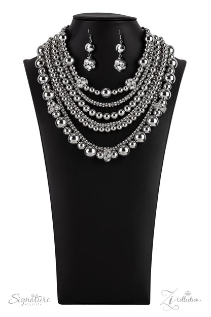 Held together by rectangular silver frames, a couture-clutching collection of oversized silver beads interspersed with white rhinestone encrusted ornaments alternates with interlocking rows of white rhinestone encrusted chains across the chest. Edgily enhanced with linked rows of silver chain fittings, the emboldened silver layers demand to be seen with their unapologetic attitude. Features an adjustable clasp closure.  All Paparazzi Accessories are lead free and nickel free!