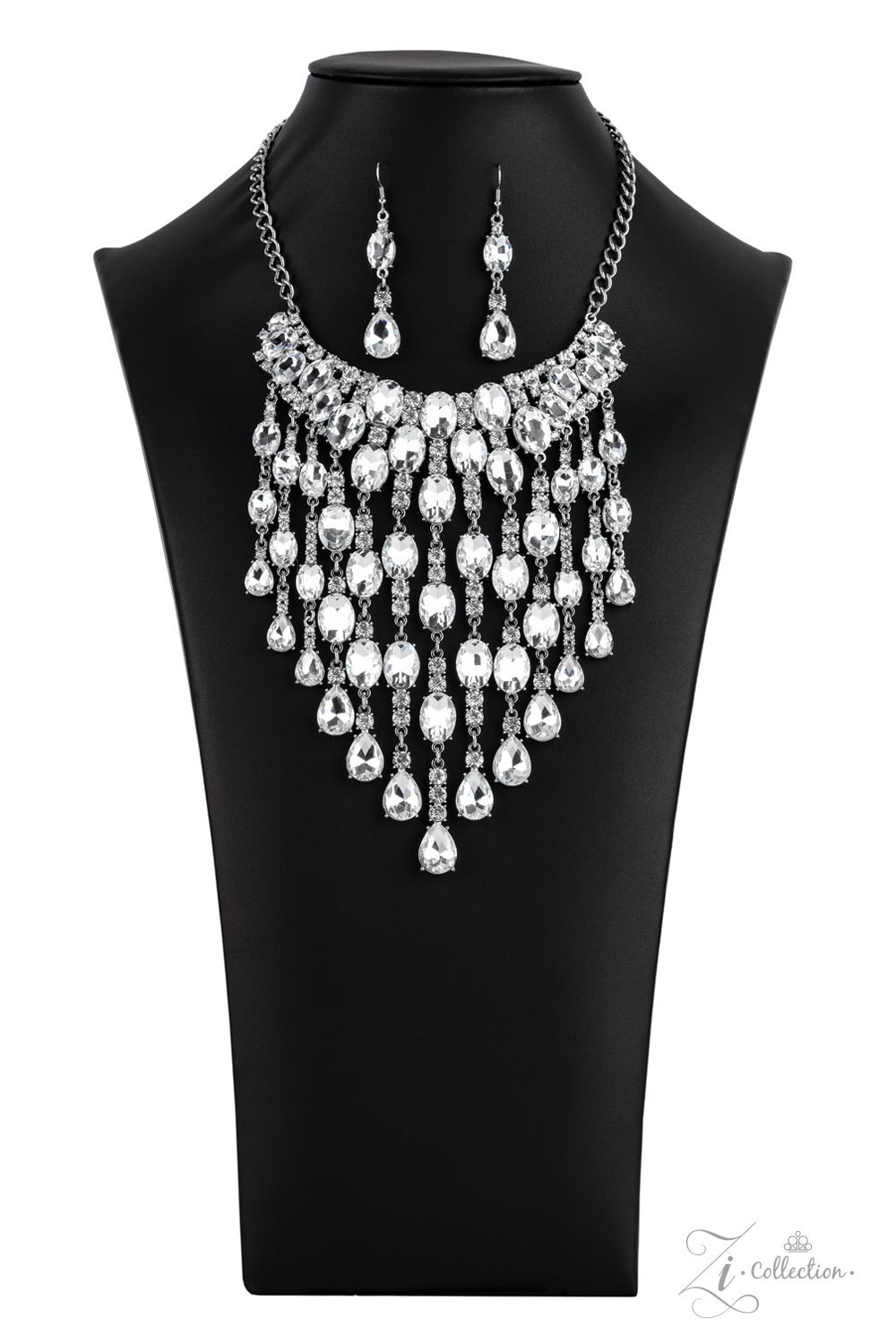 Majestic 2021 Zi Collection Necklace - Paparazzi Accessories  An intoxicating display of oversized oval and teardrop white gems dramatically drip below the collar. Enhanced with majestically mismatched white rhinestone fittings, the twinkly tassels cascade from the bottom of overloaded rhinestone encrusted silver frames that attach to a classic silver chain for the ultimate statement-making finish. Features an adjustable clasp closure. Includes one pair of matching earrings.