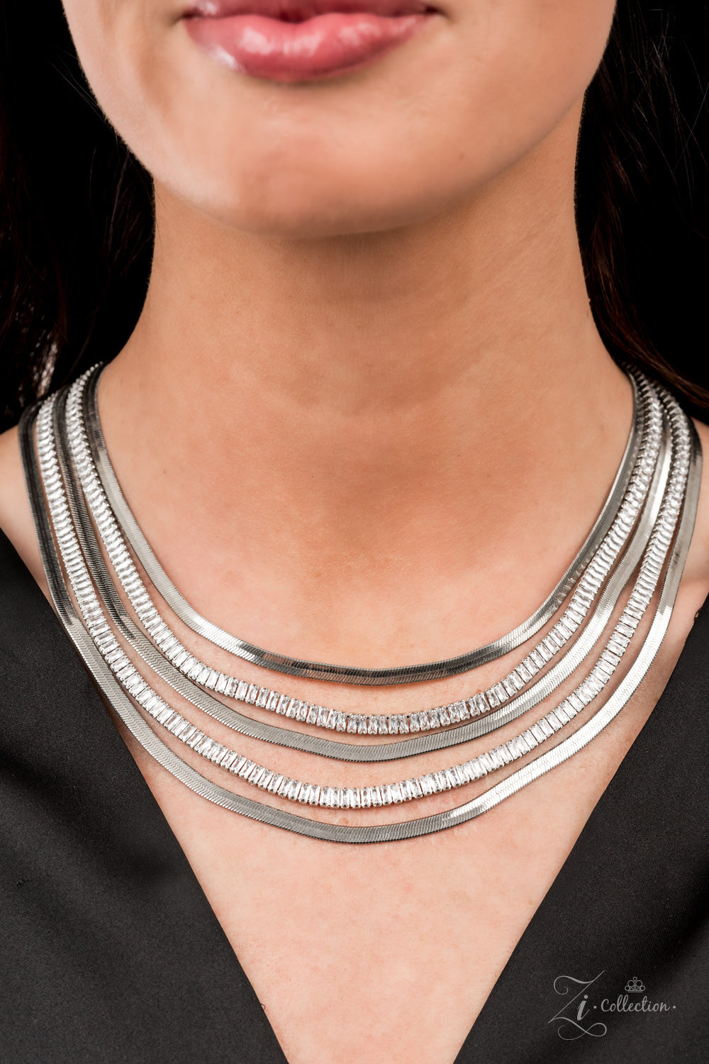 Persuasive 2021 Zi Collection Necklace - Paparazzi Accessories  Alternating rows of flat silver snake chain and glassy strands of edgy emerald cut rhinestones sleekly layer below the collar. The deceptively simple metallic silver and white rhinestone palette is unapologetically mesmerizing, making this smooth statement piece an instant classic. Features an adjustable clasp closure.  Sold as one individual necklace. Includes one pair of matching earrings.