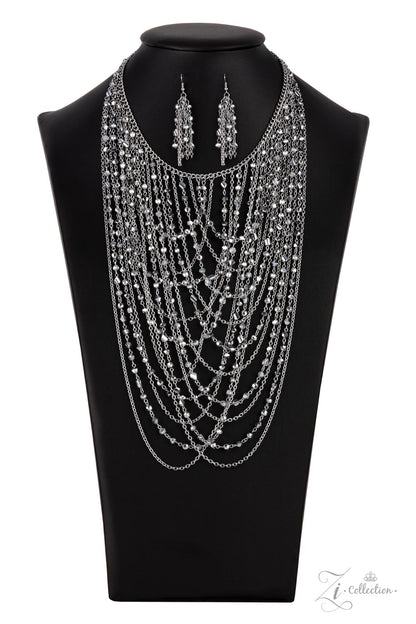Enticing 2021 Zi Collection Necklace - Paparazzi Accessories  An entrancing collection of raw cut, faceted, and crystal-like silver and hematite beads delicately connect into glitzy strands that dauntlessly drape across the chest. Intermixed with plain silver chains, the swooping layers sway with every movement, creating an audaciously audible shimmer. Features an adjustable clasp closure. Sold as one individual necklace. Includes one pair of matching earrings.
