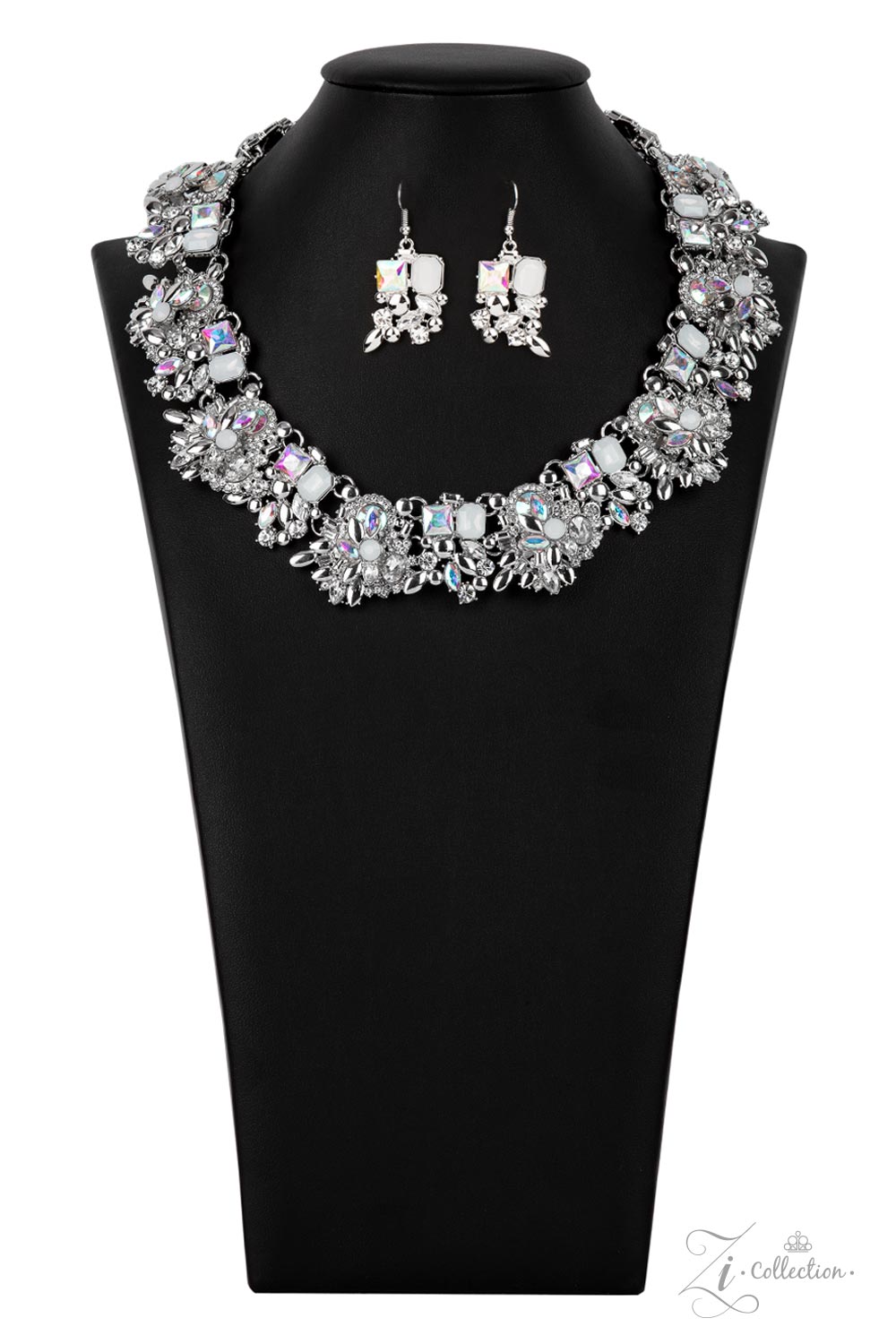 Exceptional 2021 Zi Collection Necklace - Paparazzi Accessories  An irresistible collection of iridescent, classic white, and milky white rhinestones intentionally coalesces and stacks into opulent silver accented frames. Varying in size and cuts, the mismatched rhinestone spangled frames regally link below the collar, adding dramatic dimension to this majestic knockout with a dash of stellar 3D sparkle. Features an adjustable clasp closure. Includes one pair of matching earrings.