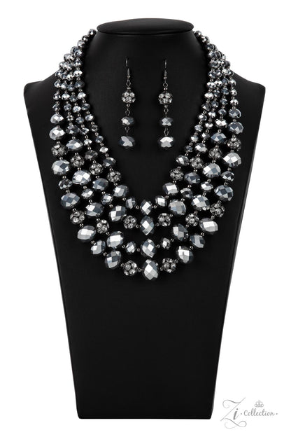Influential 2021 Zi Collection Necklace - Paparazzi Accessories  Gradually increasing in size and intensity, dainty gunmetal beads, faceted hematite-like crystals, and white rhinestone studded gunmetal ornaments unapologetically connect into dauntless rows below the collar. The radiantly regal layers flash and refract the light, creating a smoldering statement piece. Features an adjustable clasp closure.  Sold as one individual necklace. Includes one pair of matching earrings.
