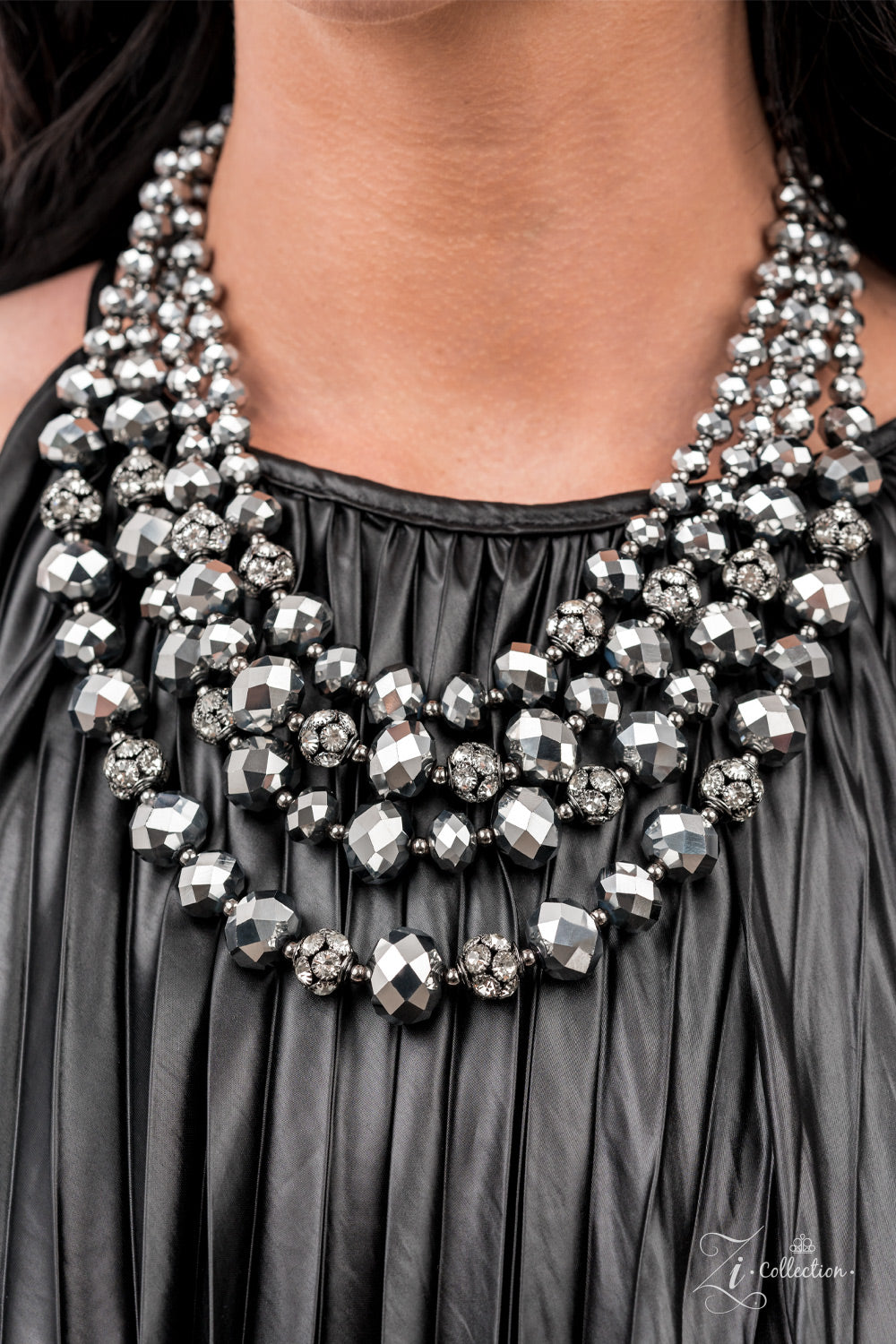 Influential 2021 Zi Collection Necklace - Paparazzi Accessories  Gradually increasing in size and intensity, dainty gunmetal beads, faceted hematite-like crystals, and white rhinestone studded gunmetal ornaments unapologetically connect into dauntless rows below the collar. The radiantly regal layers flash and refract the light, creating a smoldering statement piece. Features an adjustable clasp closure.  Sold as one individual necklace. Includes one pair of matching earrings.
