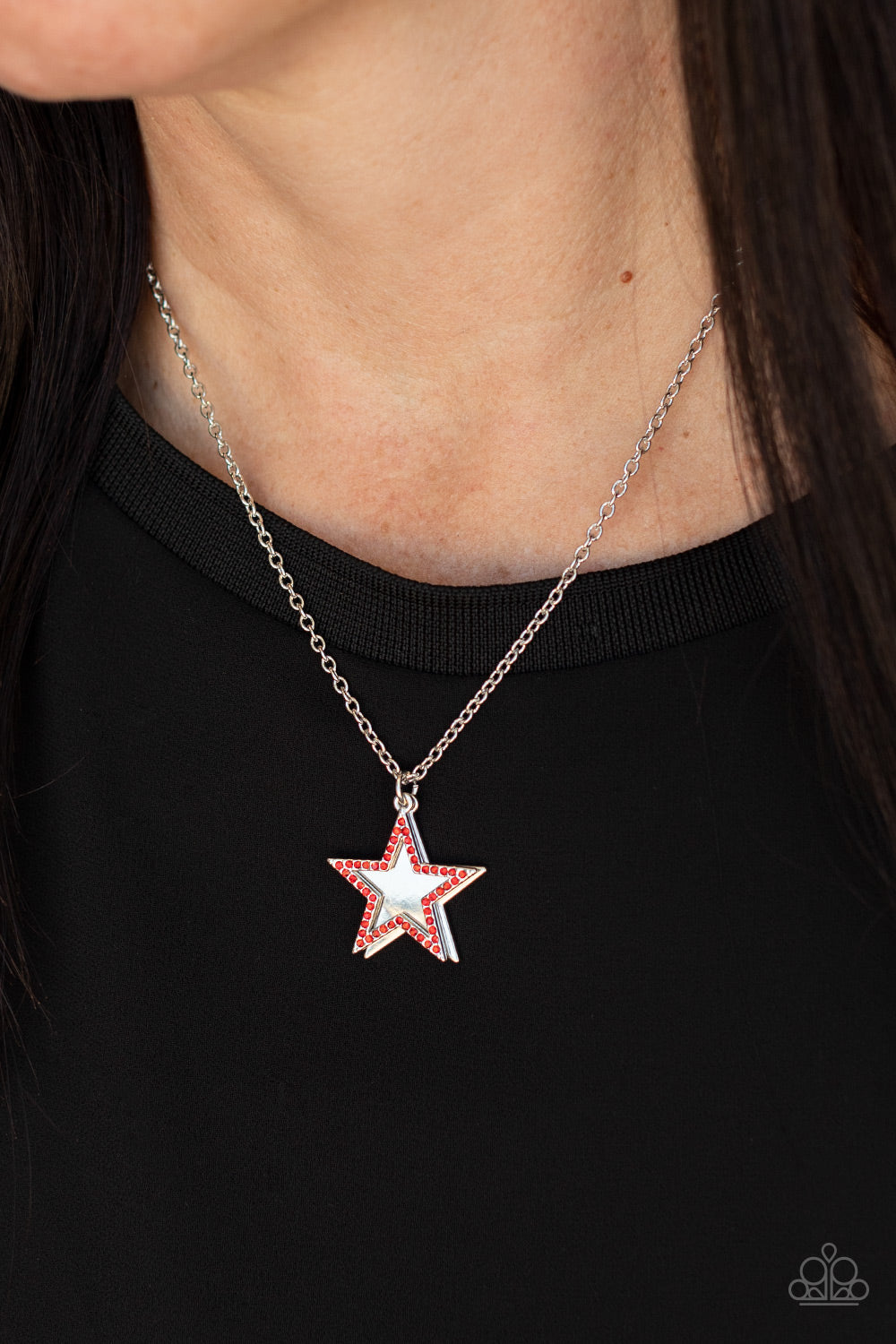 American Anthem Red Necklace - Paparazzi Accessories  A red rhinestone encrusted silver star delicately overlaps with a shiny silver star below the collar, creating a sparkly patriotic pendant. Features an adjustable clasp closure.  Sold as one individual necklace. Includes one pair of matching earrings.